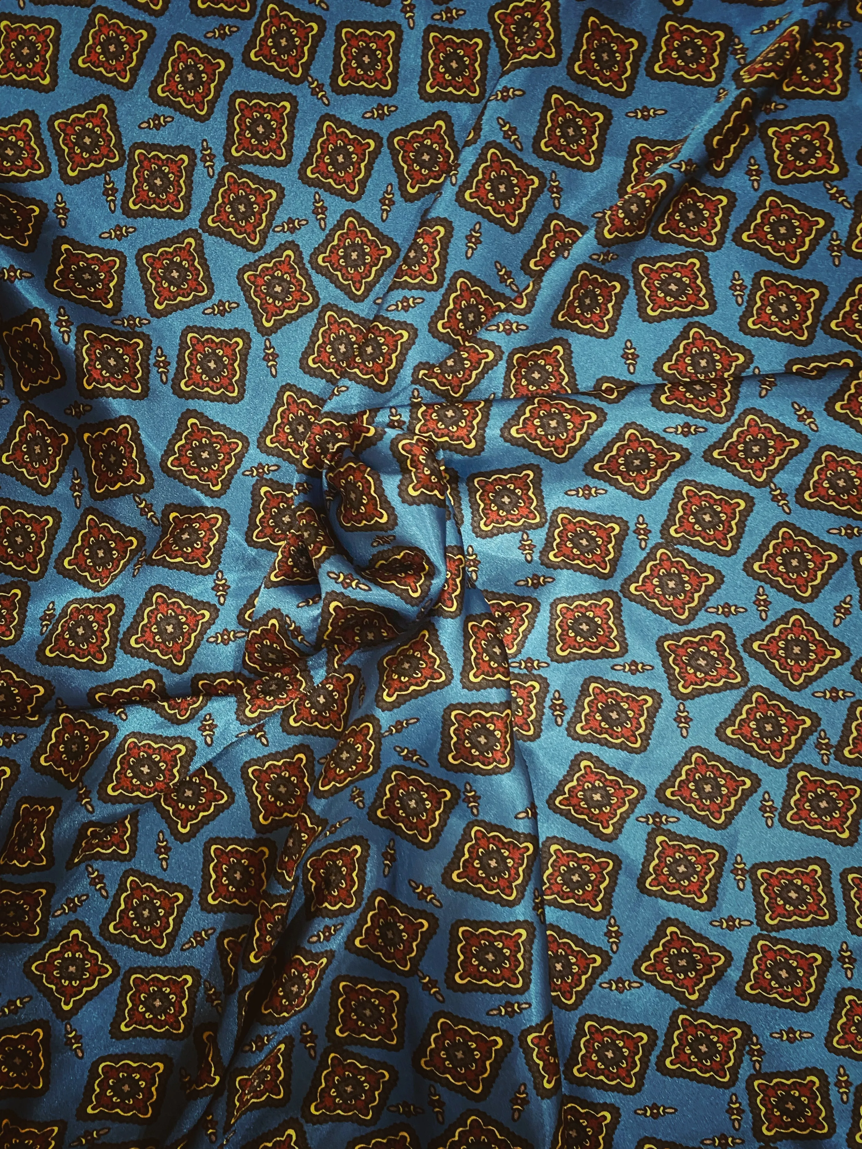Striking blue, burgundy, tan and black silky charmeuse  print.